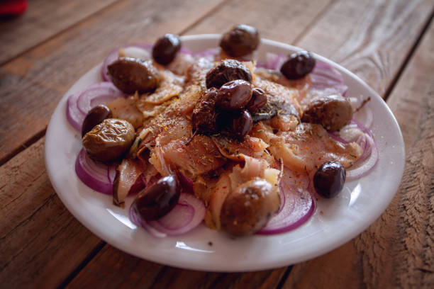 istock Seafood snack - salted raw mackerel with red onions and olives 1054457294