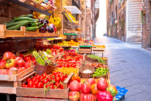 Fruit and vegetable market in narrow Florence street, Tuscany region of Italy