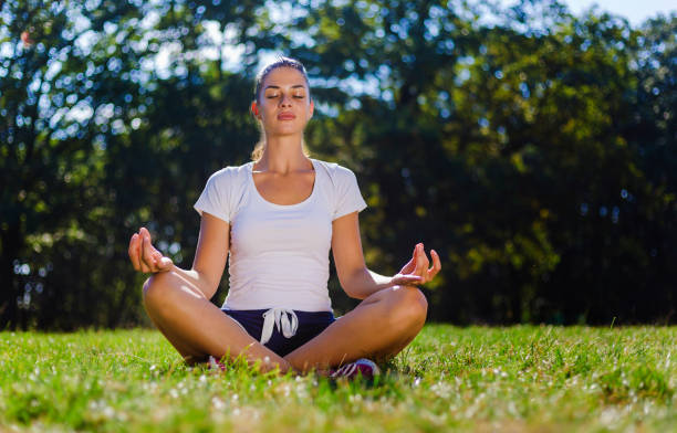 istock Beautiful woman meditating in nature 1054464256