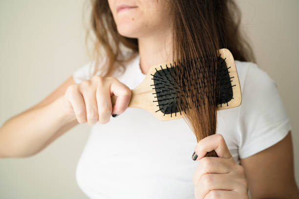 istock Woman brushing her hair 1054468058