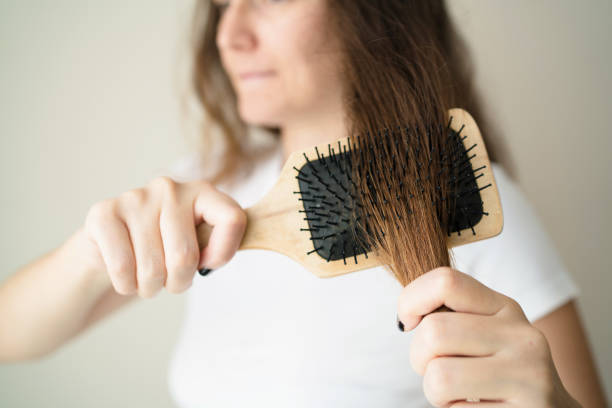 istock Woman brushing her hair 1054470312