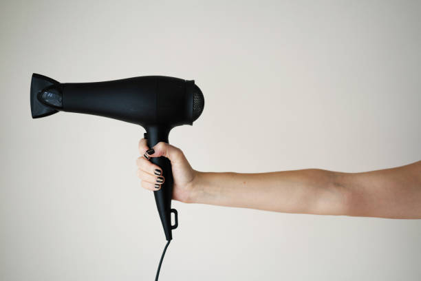 istock Hair dryer in woman's hand 1054470792
