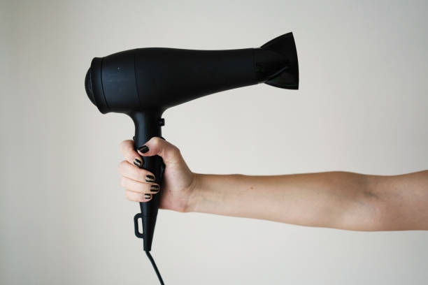 istock Hair dryer in woman's hand 1054470808