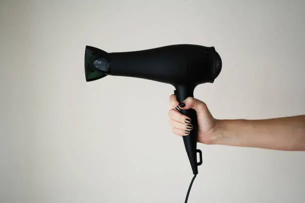 Hair dryer in woman's hand
