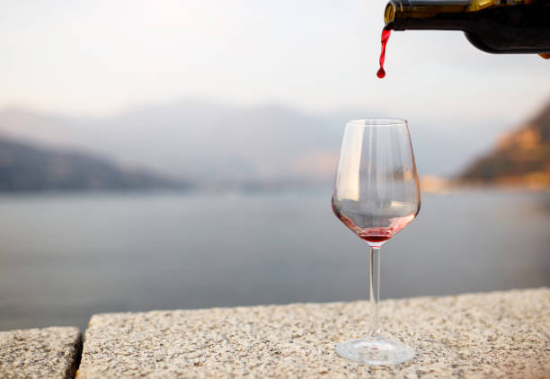 Close-up of red wine being poured in from a bottle into the glass