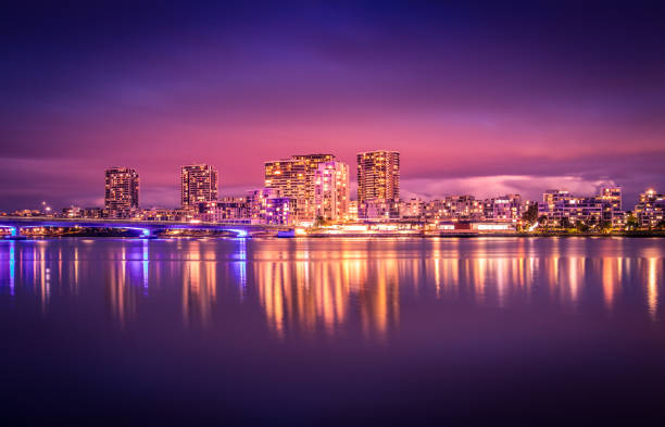 istock Modern apartments in a medium density suburb along the river. Reflections in the water. Dusk sky. 1054477384