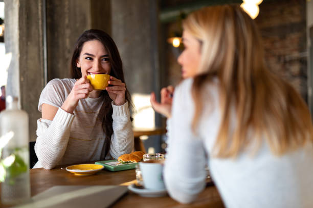 istock Female friends talking in cafe 1054478930