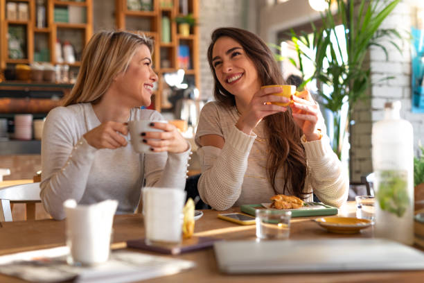 istock Girls gossiping at cafe restaurant 1054478952