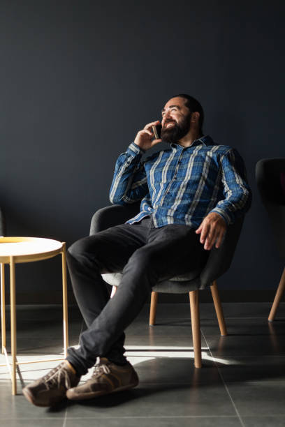 istock Happy handsome beard man talking on mobile phone 1054479074