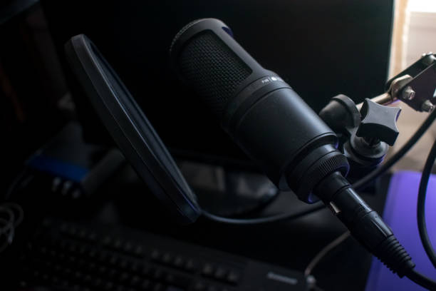 istock Closeup Black Microphone in home  recording studio with pop shield on mic stand 1054483004