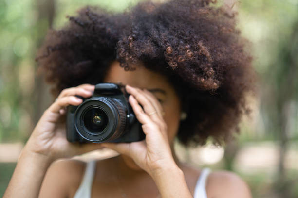 istock Woman taking photos at park 1054483830