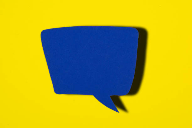 istock Blue Blank speech bubble on yellow background.Paper cut concept. 1054493884