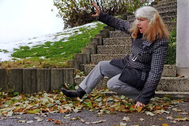 Photo of A woman slipped on wet leaves and fell. Wet leaves are dangerous