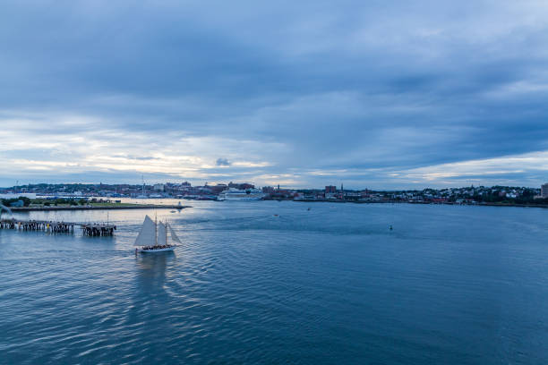 istock Sailboat and Cruise Ship in Blue Hour 1054511944