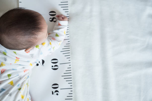 istock Baby Body and measuring tape. 1054513146