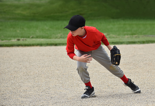 7 year old boy going toward a baseball in the field, summer
Naperville, Illinois  USA