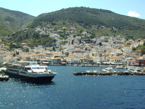 istock cruise ship facing greek island 1054513240