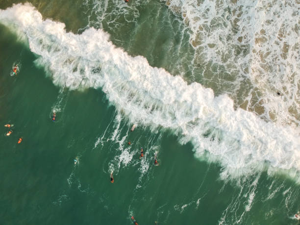 istock Aerial view of waves with people surfing, Surf 1054524290