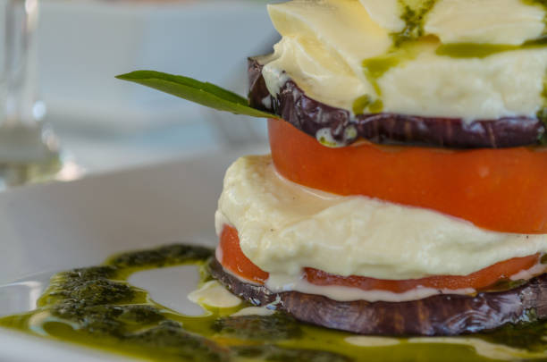 istock Mozzarella Caprese salad with eggplant, pesto and basil. 1054525452