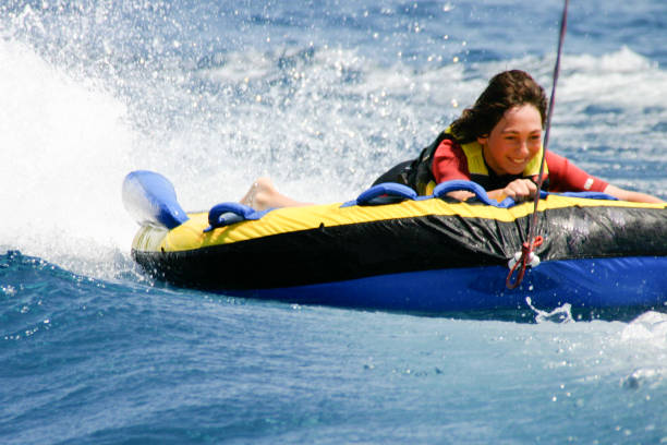 istock Young Boy Inner Tubing (Tubing) 1054531390