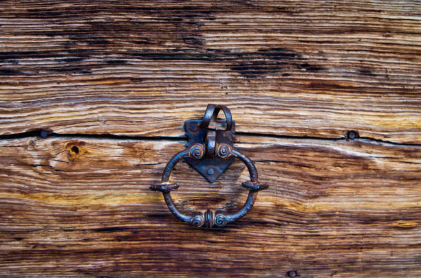 knocker in burnished metal of an ancient wooden door