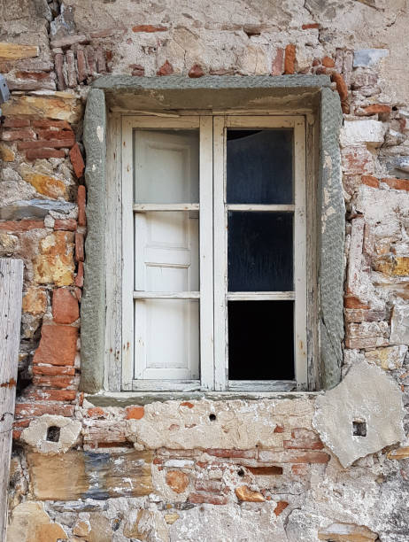 istock degraded and destroyed window of abandoned building 1054541438