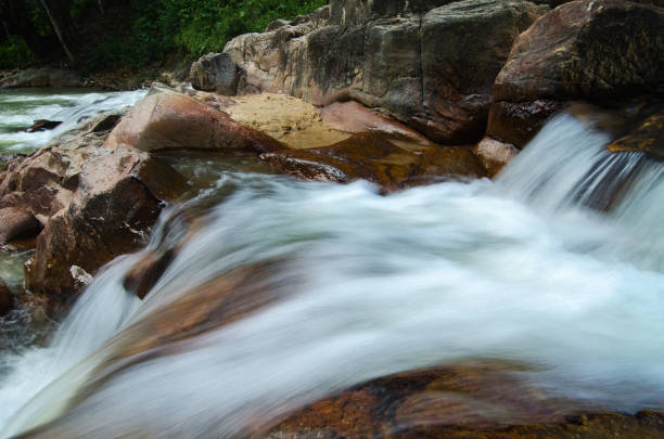 istock Beautiful in nature,amazing cascading tropical waterfall surrounded by green forest 1054548620