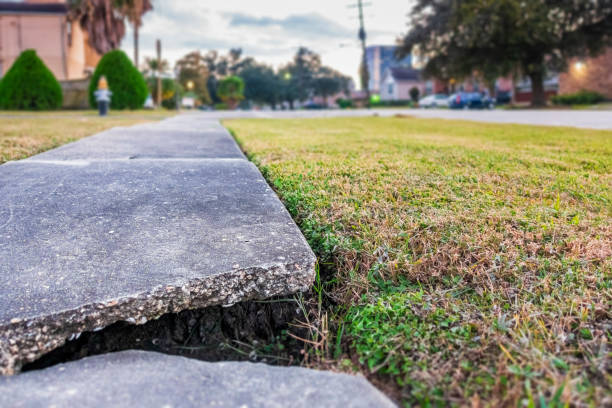 Broken concrete pedestrian footpath Broken concrete pedestrian footpath revealing a large underground cavity, posing a danger to the general public. Needs urgent repair attention from the local authority. sidewalk stock pictures, royalty-free photos & images