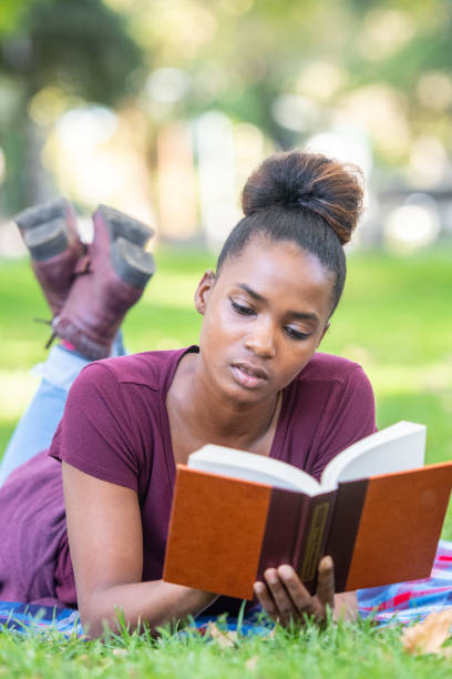 istock Serious beautiful young black woman reading a book 1054552030