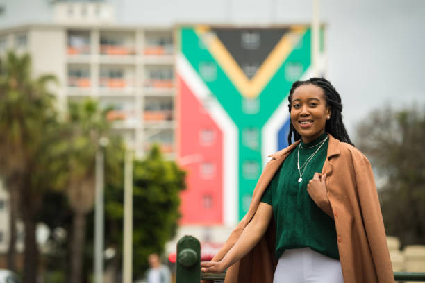 Confident South African Woman Businesswoman with the South African flag in the background south africa flag stock pictures, royalty-free photos & images