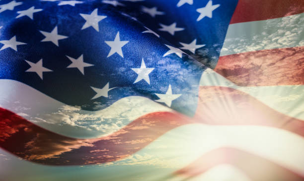 istock American flag waving in the wind at sunset or sunrise. 1054576558