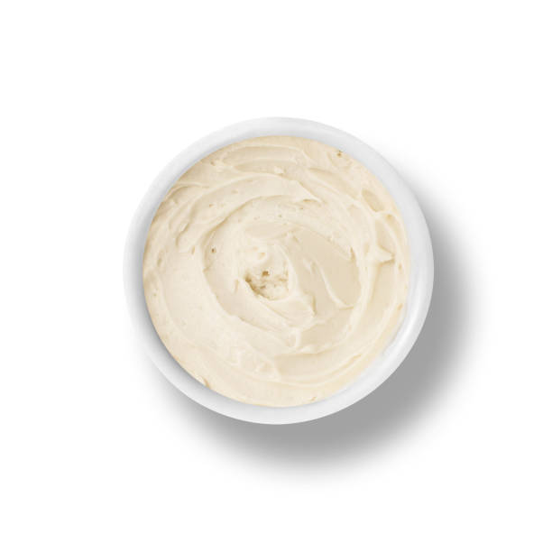 istock Container of vanilla frosting from above, isolated on white 1054576894