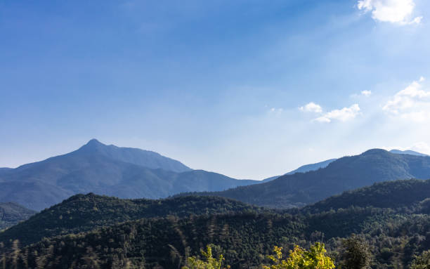 istock Mountain silhouette landscape on a blue sunny sky 1054576930
