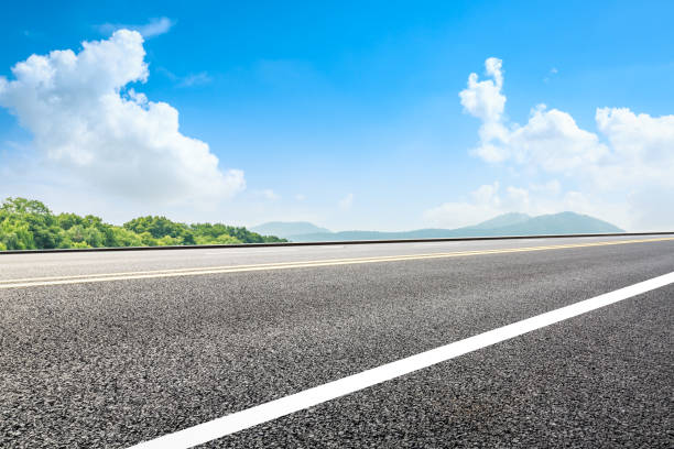 istock Asphalt road and green mountain under the blue sky 1054592776