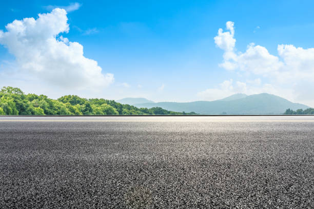 istock Asphalt road and green mountain under the blue sky 1054592846