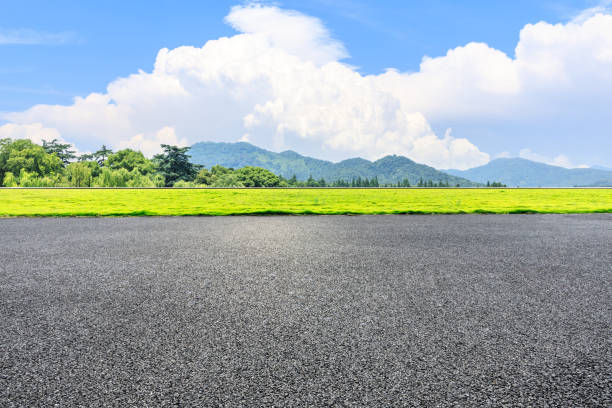 istock Asphalt road and green mountain under the blue sky 1054593242