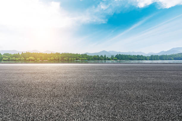 istock Asphalt road and beautiful mountain with lake under the blue sky 1054596842