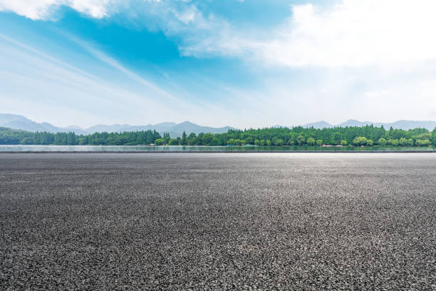 istock Asphalt road and beautiful mountain with lake under the blue sky 1054596912