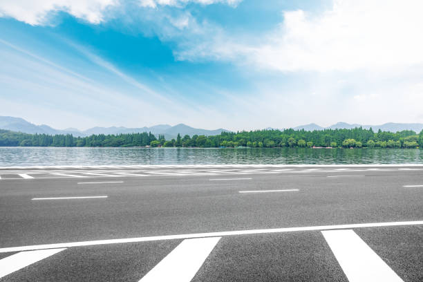 istock Asphalt road and beautiful mountain with lake under the blue sky 1054596926