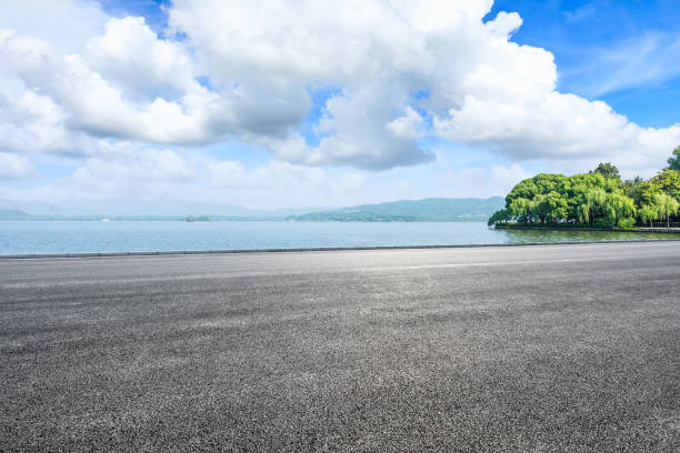 istock Asphalt road and beautiful mountain with lake under the blue sky 1054601262