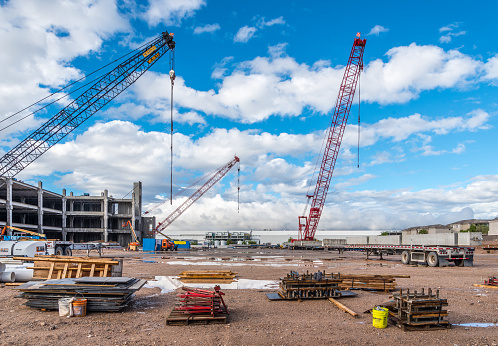Phoenix, Arizona - October 13, 2018: Giant mobile cranes and other heavy machinery stand idle at a Phoenix consruction site after a recent rainstorm.
