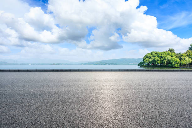 istock Asphalt road and beautiful mountain with lake under the blue sky 1054601318