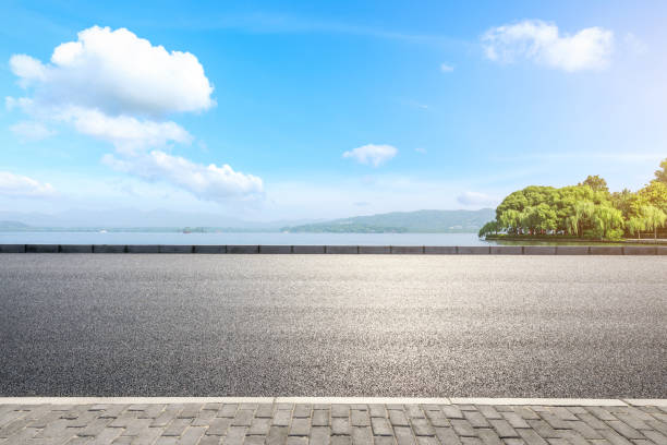 istock Asphalt road and beautiful mountain with lake under the blue sky 1054601322