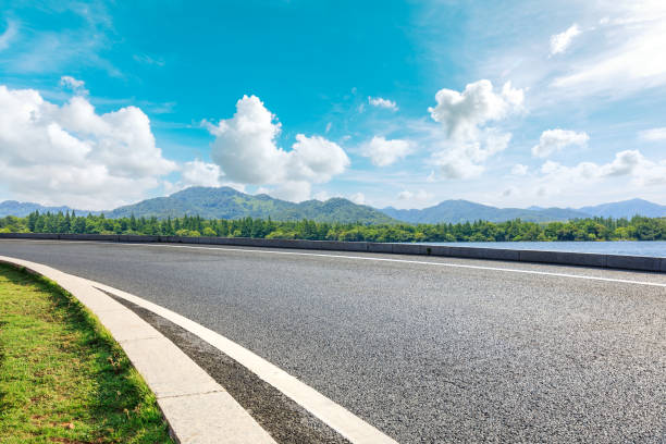 istock Asphalt road and beautiful mountain with lake under the blue sky 1054603274