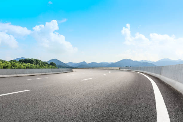 istock Asphalt road and beautiful mountain under the blue sky 1054603304