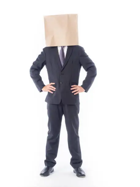 Photo of business person concept.blank space paper bag over head businessman in suit and black necktie with white background isolated.