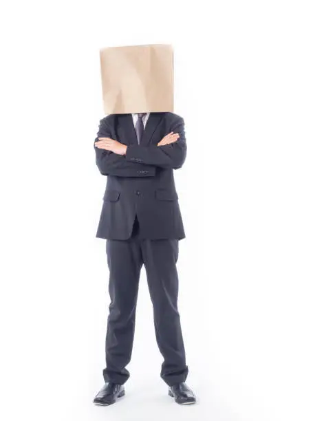 Photo of business person concept.blank space paper bag over head businessman in suit and black necktie with white background isolated.