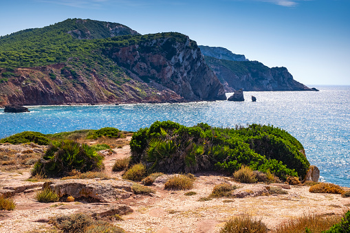 Alghero, Sardinia / Italy - 2018/08/11: Panoramic view of the Cala Porticciolo gulf with cliffs over the Cala Viola gulf in the Porto Conte Regional Park