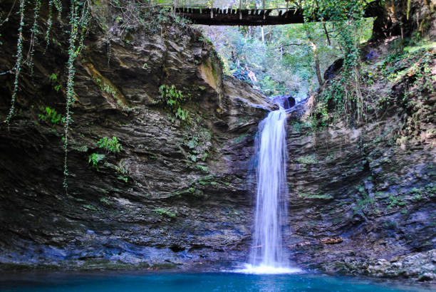 istock Beautiful waterfall in the forest 1054606922