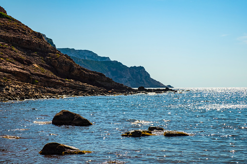 Alghero, Sardinia / Italy - 2018/08/11: Panoramic view of the Cala Porticciolo gulf with cliffs over the Cala Viola gulf in the Porto Conte Regional Park